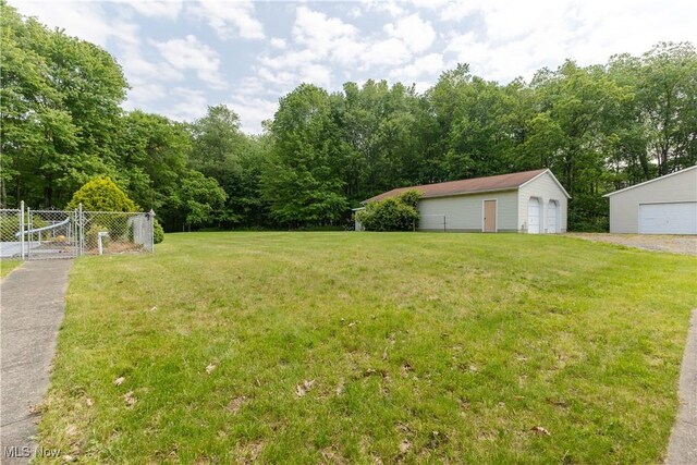 41510 Alderlick Rd, Wellsville, OH 43968 - view of yard with a gate, a detached garage, and an outbuilding