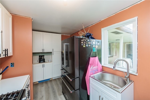 10229 State Rd, North Royalton, OH 44133 - kitchen with a sink, high quality fridge, light wood-style flooring, and white cabinets