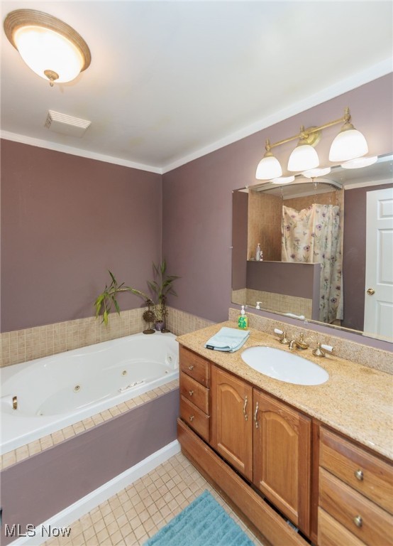 10229 State Rd, North Royalton, OH 44133 - full bath featuring a whirlpool tub, vanity, and ornamental molding