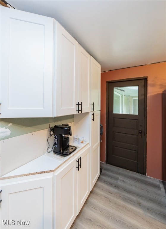 10229 State Rd, North Royalton, OH 44133 - kitchen with white cabinetry, light countertops, and light wood-style flooring