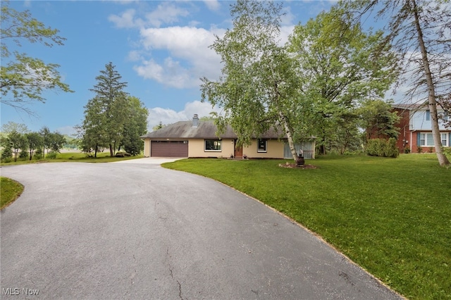 10229 State Rd, North Royalton, OH 44133 - view of front of house featuring asphalt driveway, an attached garage, a front lawn, and a chimney