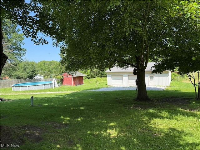5301 S Ridge Rd W, Ashtabula, OH 44004 - view of yard with an outdoor structure, an outdoor pool, and a garage