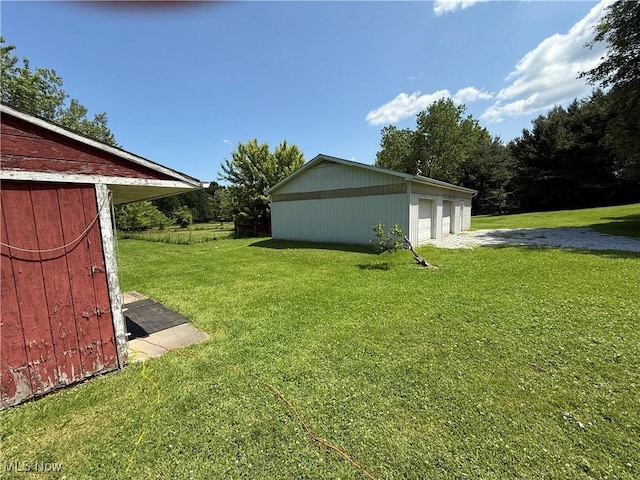 5301 S Ridge Rd W, Ashtabula, OH 44004 - view of grassy yard featuring a garage and an outbuilding