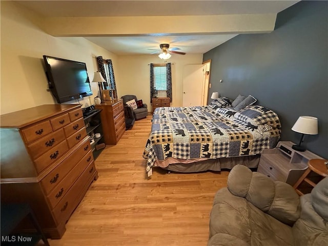 5301 S Ridge Rd W, Ashtabula, OH 44004 - bedroom with light wood-style flooring, beamed ceiling, and a ceiling fan