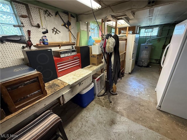 5301 S Ridge Rd W, Ashtabula, OH 44004 - basement with a workshop area, gas water heater, and freestanding refrigerator