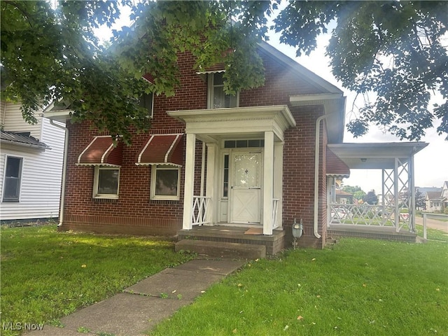 307 N 8th St, Coshocton, OH 43812 - view of front of property featuring brick siding and a front yard