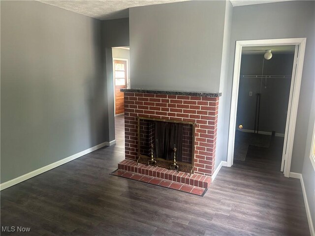 307 N 8th St, Coshocton, OH 43812 - unfurnished living room featuring wood finished floors, baseboards, and a fireplace