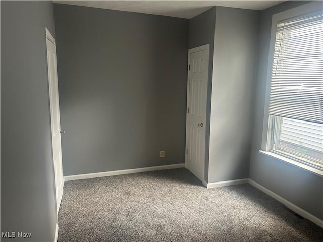 307 N 8th St, Coshocton, OH 43812 - empty room with carpet flooring, baseboards, and healthy amount of natural light