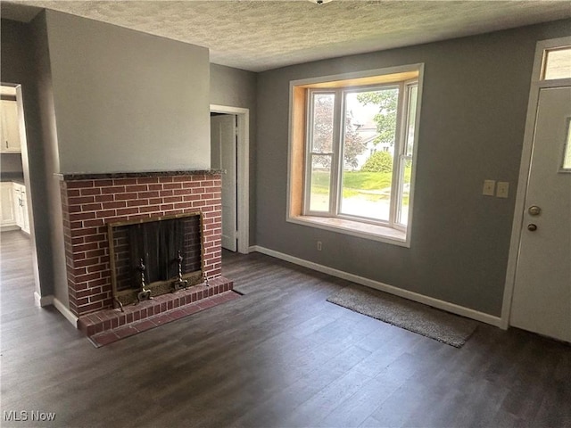 307 N 8th St, Coshocton, OH 43812 - unfurnished living room featuring wood finished floors, a fireplace, a textured ceiling, and baseboards