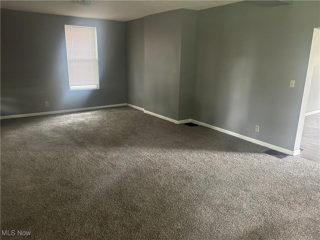 307 N 8th St, Coshocton, OH 43812 - unfurnished room with baseboards and dark carpet
