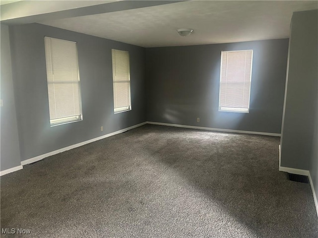 307 N 8th St, Coshocton, OH 43812 - unfurnished room with dark colored carpet, baseboards, and plenty of natural light