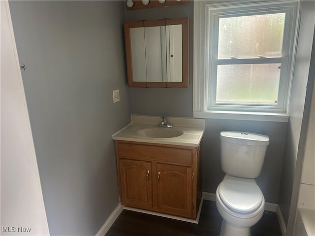 307 N 8th St, Coshocton, OH 43812 - bathroom featuring vanity, toilet, healthy amount of natural light, and baseboards