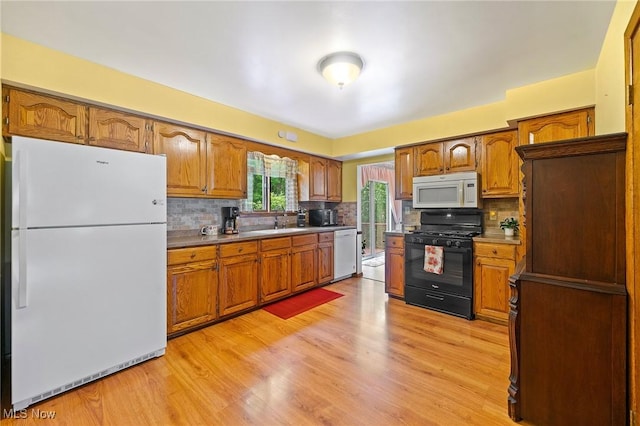 2322 Westview Rd, Cortland, OH 44410 - kitchen with white appliances, brown cabinets, decorative backsplash, and light wood-type flooring
