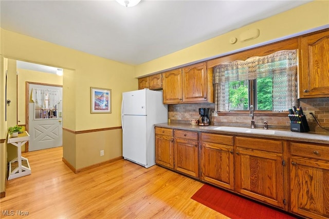 2322 Westview Rd, Cortland, OH 44410 - kitchen featuring freestanding refrigerator, a sink, brown cabinetry, and decorative backsplash