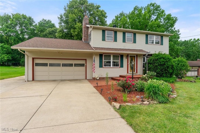 2322 Westview Rd, Cortland, OH 44410 - traditional home featuring concrete driveway, a garage, and a front yard