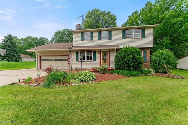 2322 Westview Rd, Cortland, OH 44410 - view of front of house with an attached garage, concrete driveway, a chimney, and a front yard