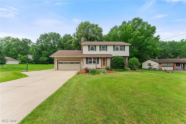 2322 Westview Rd, Cortland, OH 44410 - view of front of property with a garage, driveway, a front yard, a chimney, and view of scattered trees