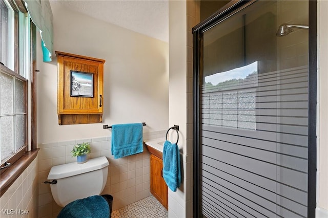 2322 Westview Rd, Cortland, OH 44410 - bathroom with toilet, a stall shower, tile walls, tile patterned flooring, and vanity