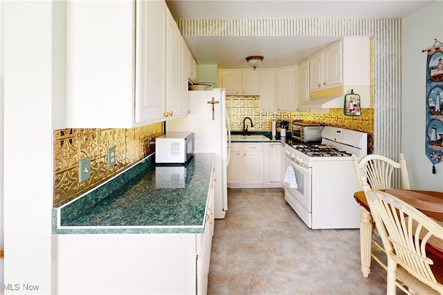 132 Karen Pl, Wintersville, OH 43953 - kitchen with white appliances, a sink, backsplash, and white cabinetry