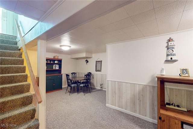 132 Karen Pl, Wintersville, OH 43953 - carpeted dining space featuring stairs and wooden walls