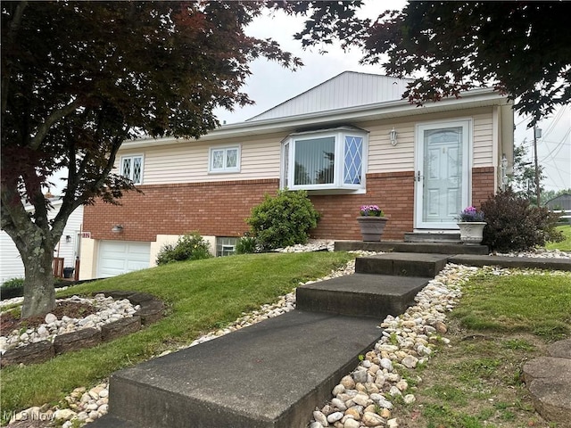 132 Karen Pl, Wintersville, OH 43953 - view of front of home featuring brick siding, an attached garage, and a front yard