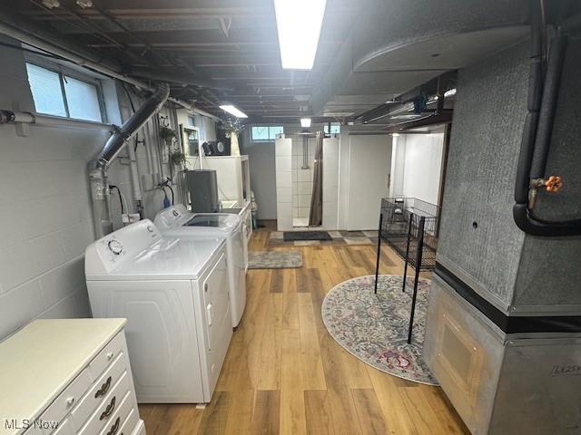 3232 Circle Dr, Cortland, OH 44410 - below grade area featuring washer and clothes dryer, light wood finished floors, and concrete block wall