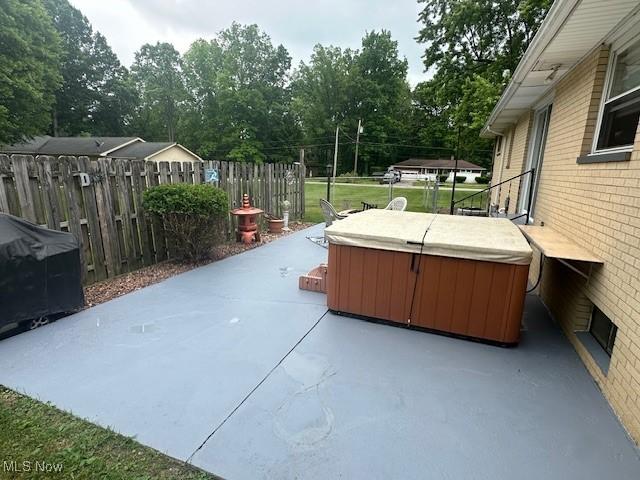 3232 Circle Dr, Cortland, OH 44410 - view of patio featuring a hot tub and view of scattered trees