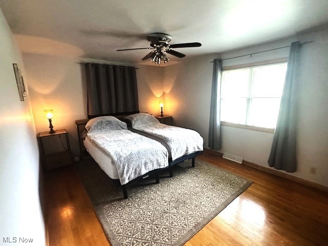 3232 Circle Dr, Cortland, OH 44410 - bedroom with wood finished floors, baseboards, and a ceiling fan