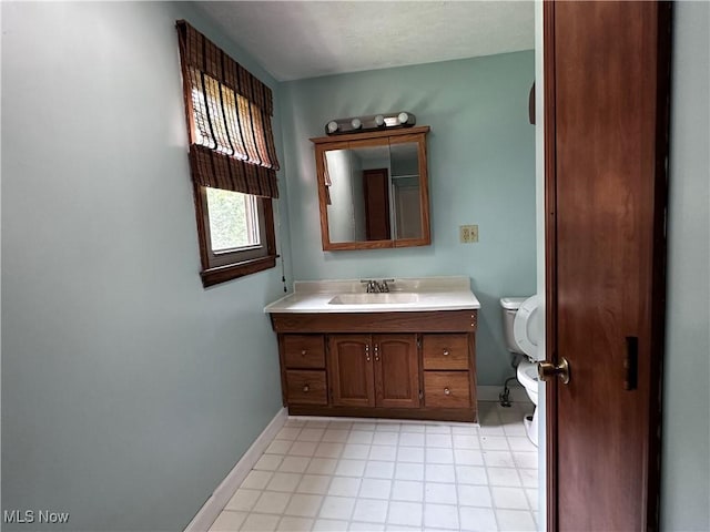 1029 Fowler Dr, Caldwell, OH 43724 - half bathroom featuring baseboards, toilet, vanity, and tile patterned flooring
