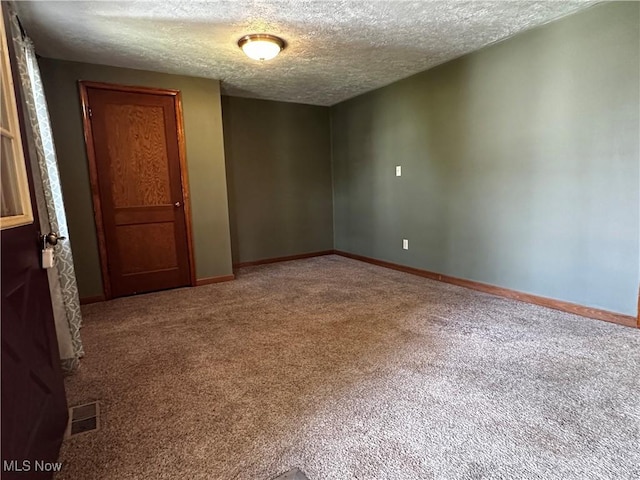 1029 Fowler Dr, Caldwell, OH 43724 - carpeted empty room with a textured ceiling and baseboards