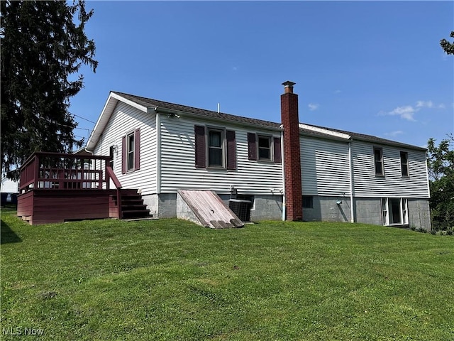 1029 Fowler Dr, Caldwell, OH 43724 - back of house featuring a chimney, a yard, and a deck