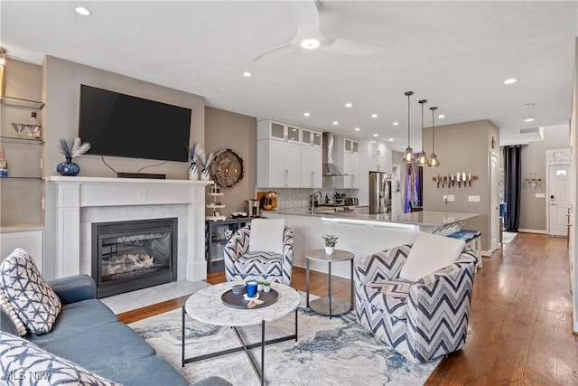 2164 W 6th St, Cleveland, OH 44113 - living area featuring light wood finished floors, a ceiling fan, recessed lighting, and a high end fireplace
