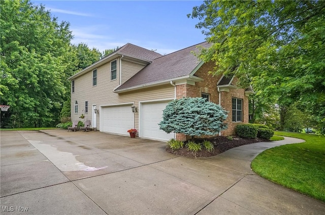 2634 Deer Ridge Run, Cuyahoga Falls, OH 44223 - view of property exterior featuring driveway, brick siding, and roof with shingles