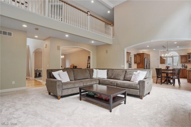 2634 Deer Ridge Run, Cuyahoga Falls, OH 44223 - living area with a towering ceiling, recessed lighting, a chandelier, arched walkways, and light colored carpet