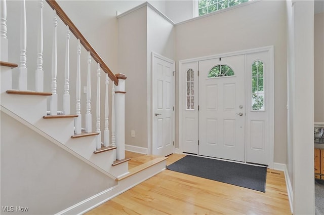 2634 Deer Ridge Run, Cuyahoga Falls, OH 44223 - entryway with stairs, wood finished floors, and a towering ceiling