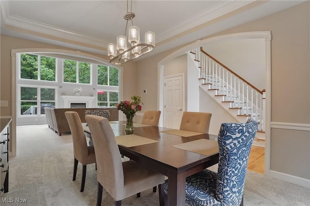 2634 Deer Ridge Run, Cuyahoga Falls, OH 44223 - dining space with crown molding, light carpet, a chandelier, arched walkways, and stairs
