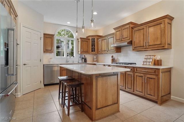 2634 Deer Ridge Run, Cuyahoga Falls, OH 44223 - kitchen with appliances with stainless steel finishes, brown cabinets, light countertops, under cabinet range hood, and light tile patterned floors