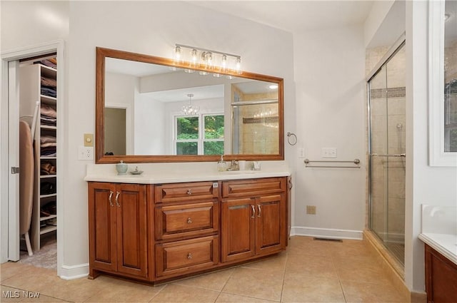 2634 Deer Ridge Run, Cuyahoga Falls, OH 44223 - bathroom with double vanity, a stall shower, tile patterned flooring, and a walk in closet