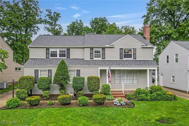 1120 Croyden Rd, Lyndhurst, OH 44124 - traditional-style house featuring a front yard, covered porch, roof with shingles, and a chimney