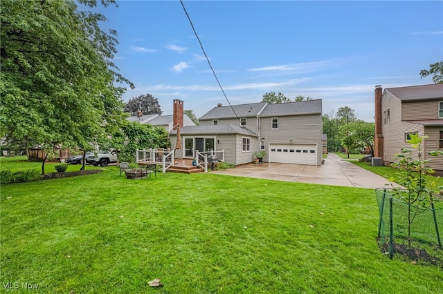 1120 Croyden Rd, Lyndhurst, OH 44124 - rear view of property featuring an attached garage, a wooden deck, driveway, and a lawn