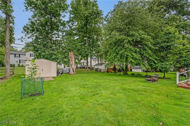 1120 Croyden Rd, Lyndhurst, OH 44124 - view of grassy yard with a storage unit and a fire pit