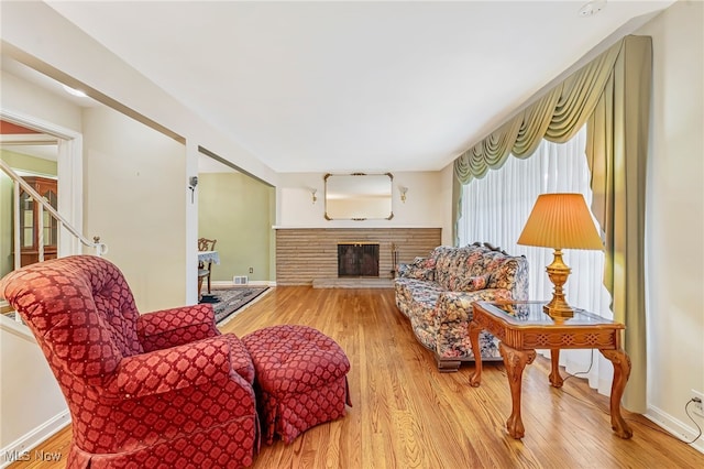 1120 Croyden Rd, Lyndhurst, OH 44124 - living room featuring a stone fireplace and wood finished floors