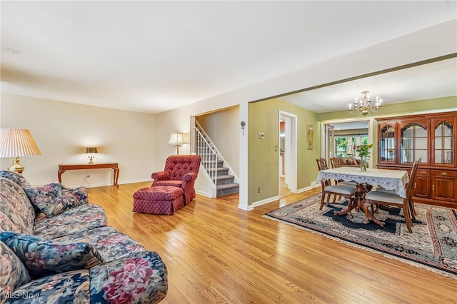 1120 Croyden Rd, Lyndhurst, OH 44124 - living room featuring wood finished floors, a chandelier, and stairway