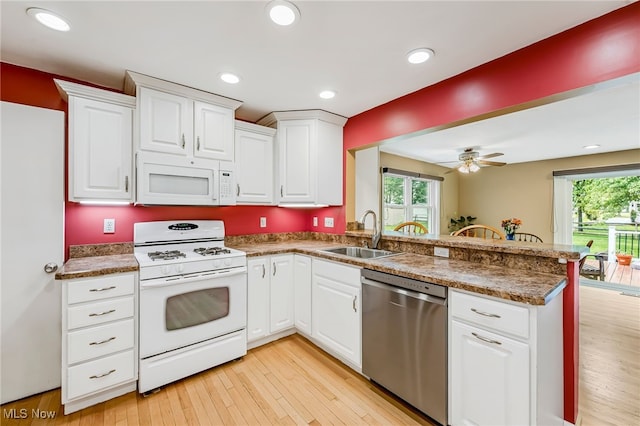 1120 Croyden Rd, Lyndhurst, OH 44124 - kitchen with white appliances, a peninsula, plenty of natural light, white cabinetry, and recessed lighting