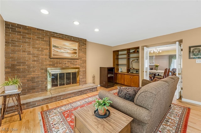 1120 Croyden Rd, Lyndhurst, OH 44124 - living room with light wood-style flooring, a chandelier, a fireplace, and recessed lighting