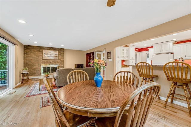 1120 Croyden Rd, Lyndhurst, OH 44124 - dining space with light wood finished floors, recessed lighting, and a brick fireplace