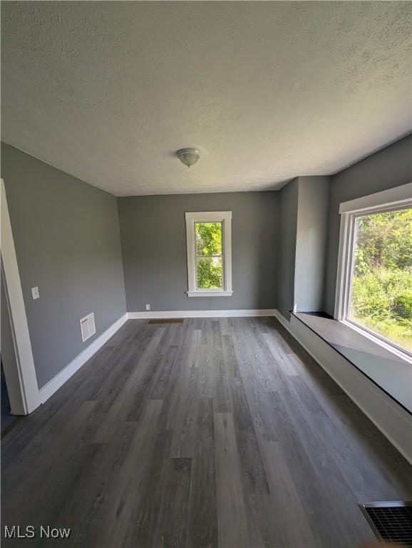 908 W 8th St, Lorain, OH 44052 - unfurnished room with a textured ceiling and dark wood finished floors