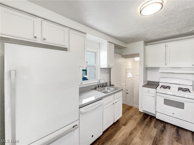 24451 Devoe Ave, Euclid, OH 44123 - kitchen featuring white appliances, under cabinet range hood, dark wood-style floors, white cabinets, and a textured ceiling