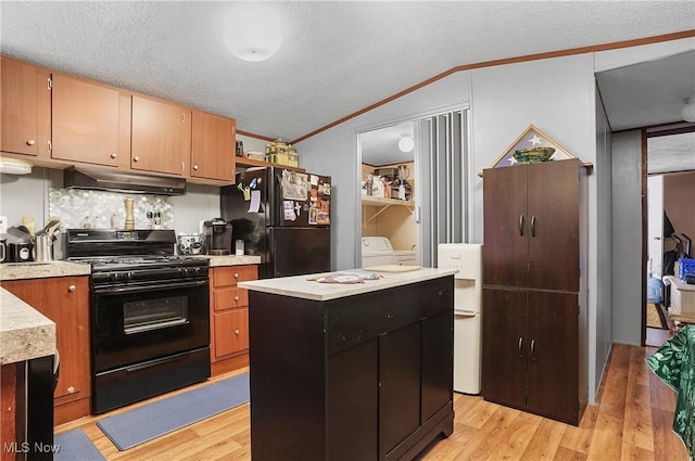 28 E Buddy St, New Franklin, OH 44203 - kitchen with black appliances, under cabinet range hood, light countertops, crown molding, and light wood-style flooring