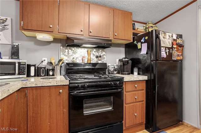 28 E Buddy St, New Franklin, OH 44203 - kitchen featuring black appliances, range hood, light countertops, light wood-style floors, and crown molding